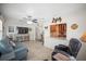 The comfortable living room features tile floors, access to dining room, and a large TV at 3502 18Th Avenue W Dr, Bradenton, FL 34205