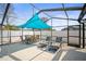 Outdoor patio with seating area covered by a blue sun shade at 3502 18Th Avenue W Dr, Bradenton, FL 34205