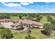 Aerial view of a sprawling estate featuring a beautiful home, manicured lawns, and mature trees at 3551 Ridgeland Ct, Punta Gorda, FL 33982