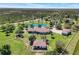 Stunning home with a red tile roof, guest house, and a tranquil pond surrounded by lush greenery at 3551 Ridgeland Ct, Punta Gorda, FL 33982