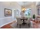 Elegant dining room features wood floors, a tray ceiling, and a decorative chandelier at 3551 Ridgeland Ct, Punta Gorda, FL 33982