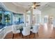 Elegant dining room featuring a glass table, stylish chairs, and a picturesque window overlooking the beautiful landscape at 3551 Ridgeland Ct, Punta Gorda, FL 33982