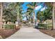 Elegant gated entrance flanked by palm trees and manicured landscaping, offering privacy and curb appeal at 3551 Ridgeland Ct, Punta Gorda, FL 33982