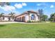 Well-manicured lawn and attractive exterior showcasing the attached garages at 3551 Ridgeland Ct, Punta Gorda, FL 33982