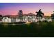 Stunning single-story home with landscaped yard, bathed in the warm glow of twilight at 3551 Ridgeland Ct, Punta Gorda, FL 33982