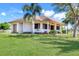 Inviting exterior with covered porch and a well-maintained yard at 3551 Ridgeland Ct, Punta Gorda, FL 33982