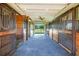 Spacious horse barn featuring multiple stalls and durable flooring at 3551 Ridgeland Ct, Punta Gorda, FL 33982