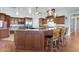 Open kitchen featuring a large island with bar seating, custom cabinets, and stainless steel appliances at 3551 Ridgeland Ct, Punta Gorda, FL 33982