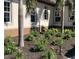 Beautifully landscaped garden beds with blooming flowers and palm trees accent the home's exterior at 3551 Ridgeland Ct, Punta Gorda, FL 33982