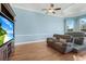 Comfortable living room with a large TV, plush seating, and tray ceiling at 3551 Ridgeland Ct, Punta Gorda, FL 33982