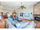 Bright, open-concept living room featuring wood floors, a stone fireplace, and a view of the kitchen at 3551 Ridgeland Ct, Punta Gorda, FL 33982