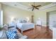 This spacious main bedroom features a tray ceiling, ceiling fan and hardwood floors at 3551 Ridgeland Ct, Punta Gorda, FL 33982