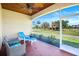 Relaxing screened porch with comfortable seating and a view of the expansive yard at 3551 Ridgeland Ct, Punta Gorda, FL 33982