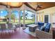 Relaxing screened-in porch with a comfortable seating area and a dining space offering scenic views of the property at 3551 Ridgeland Ct, Punta Gorda, FL 33982