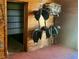 Organized tack room with saddle racks, bridle hooks, and storage shelves at 3551 Ridgeland Ct, Punta Gorda, FL 33982