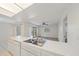 Open view of the kitchen from the living room featuring a stainless steel sink at 3909 Linwood St, Sarasota, FL 34232