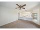 Inviting living room opens to the kitchen with a breakfast bar and a ceiling fan at 3909 Linwood St, Sarasota, FL 34232