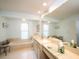 A bright bathroom featuring a large soaking tub, ample counter space, and neutral tile flooring at 3922 Wilshire Cir # 177, Sarasota, FL 34238