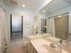 Well-lit bathroom with a large window, a bathtub-shower, and plenty of counter space and storage at 3922 Wilshire Cir # 177, Sarasota, FL 34238