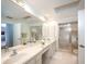 Bright bathroom features double sinks, spacious countertops, and a glass door shower at 3922 Wilshire Cir # 177, Sarasota, FL 34238