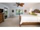 Bright bedroom with a king bed, ceiling fan, and large windows offering serene outdoor views at 3922 Wilshire Cir # 177, Sarasota, FL 34238