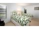 A bedroom with two twin beds, a window, and light blue walls at 3922 Wilshire Cir # 177, Sarasota, FL 34238