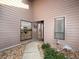 Charming home entrance with decorative rocks, walkway, and views of the kitchen through a window next to the front door at 3922 Wilshire Cir # 177, Sarasota, FL 34238