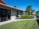 Exterior features include a grill, lush lawn, and a covered patio, perfect for outdoor entertaining at 3922 Wilshire Cir # 177, Sarasota, FL 34238