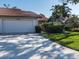 A house with a red tile roof and a well-maintained front yard at 3922 Wilshire Cir # 177, Sarasota, FL 34238