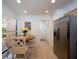 Bright kitchen with a stainless steel refrigerator and a cozy breakfast nook area at 3922 Wilshire Cir # 177, Sarasota, FL 34238