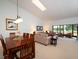 Cozy living room area next to the dining table and a window showcasing outdoor scenery at 3922 Wilshire Cir # 177, Sarasota, FL 34238