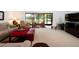 Spacious living room with large windows and plush seating, perfect for relaxation and entertaining at 3922 Wilshire Cir # 177, Sarasota, FL 34238