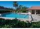 Inviting community pool area with lounge chairs and a shaded pavilion, perfect for relaxation at 3922 Wilshire Cir # 177, Sarasota, FL 34238