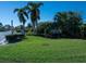 Entrance to Lakeshore Village with lush landscaping and a community sign at 3922 Wilshire Cir # 177, Sarasota, FL 34238