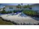 Relaxing home featuring outdoor seating surrounded by beautifully landscaped grounds at 401 63Rd St, Holmes Beach, FL 34217