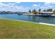 Waterfront backyard with green grass, tranquil canal access, and beautiful Florida scenery at 4216 El Dorado Cv, Bradenton, FL 34210