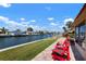 Serene patio with comfortable seating overlooking the canal, perfect for relaxation and enjoying the waterfront view at 4216 El Dorado Cv, Bradenton, FL 34210