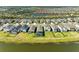A scenic aerial view showcasing a backyard pool with pond views and community amenities at 4253 Pond Brook Ct, Bradenton, FL 34211