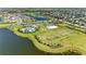 Excellent aerial view of community amenities featuring pool, playground, volleyball court and lake views at 4253 Pond Brook Ct, Bradenton, FL 34211