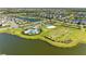 Picturesque aerial view of community amenities including pool, playground, beach volleyball court and lakes at 4253 Pond Brook Ct, Bradenton, FL 34211