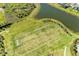 Aerial view of community green space with soccer field and lake at 4253 Pond Brook Ct, Bradenton, FL 34211