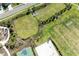 Aerial view of community park featuring a basketball court, volleyball court, and green space at 4253 Pond Brook Ct, Bradenton, FL 34211