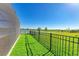 Landscaped backyard with lush green grass and serene lake view creates a peaceful outdoor oasis at 4253 Pond Brook Ct, Bradenton, FL 34211