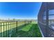Fenced backyard with lush green grass and serene water view enhances this property's outdoor appeal at 4253 Pond Brook Ct, Bradenton, FL 34211
