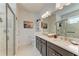 Elegant bathroom featuring a glass shower, double vanity sinks, and modern lighting fixtures, creating a luxurious feel at 4253 Pond Brook Ct, Bradenton, FL 34211