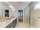 Bright bathroom featuring double sinks, modern fixtures, and a spacious glass-enclosed shower at 4253 Pond Brook Ct, Bradenton, FL 34211