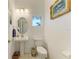 Bathroom with a pedestal sink, framed art, a decorative window, and a toilet with tissue holder and towel bar at 4253 Pond Brook Ct, Bradenton, FL 34211
