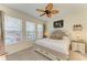 Well-lit bedroom with a ceiling fan, large windows, and a comfortable bed with accent pillows and side tables at 4253 Pond Brook Ct, Bradenton, FL 34211