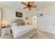 Bright bedroom featuring a comfortable bed with a bench, and an ensuite bathroom with a glass-door shower at 4253 Pond Brook Ct, Bradenton, FL 34211