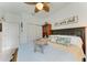 Charming bedroom featuring a wooden cabinet, ceiling fan, and comfortable bed at 4253 Pond Brook Ct, Bradenton, FL 34211